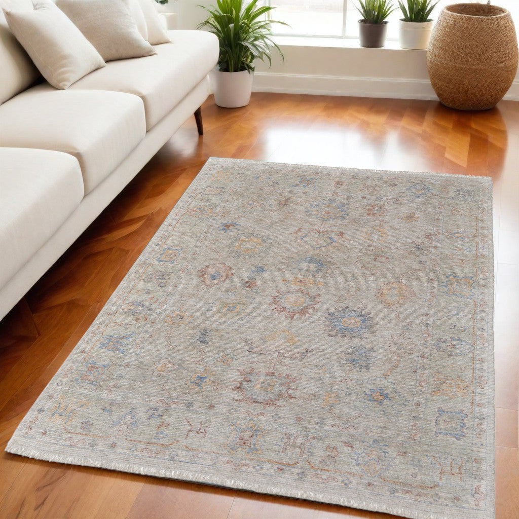 4' X 6' Tan Brown and Blue Floral Hand Woven Distressed Area Rug With Fringe