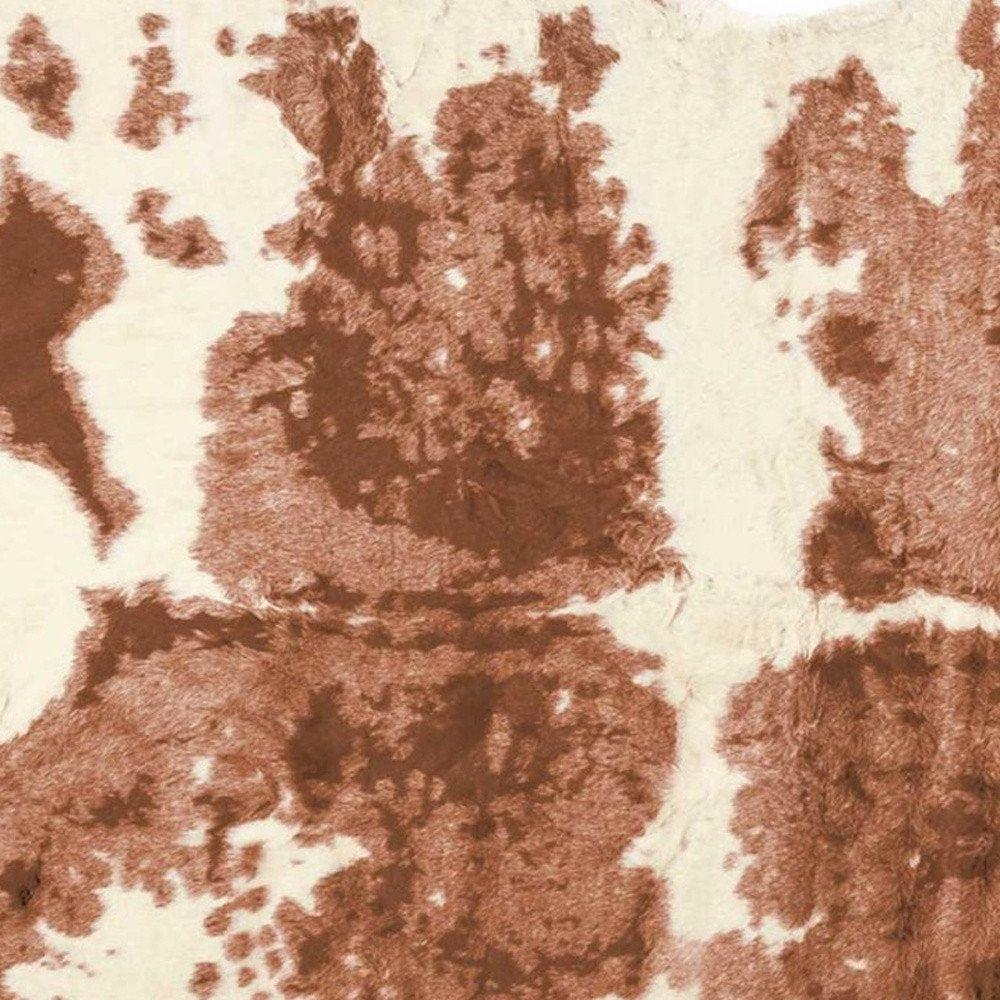 4' X 5' Brown And Ivory Faux Cowhide Animal Print Area Rug