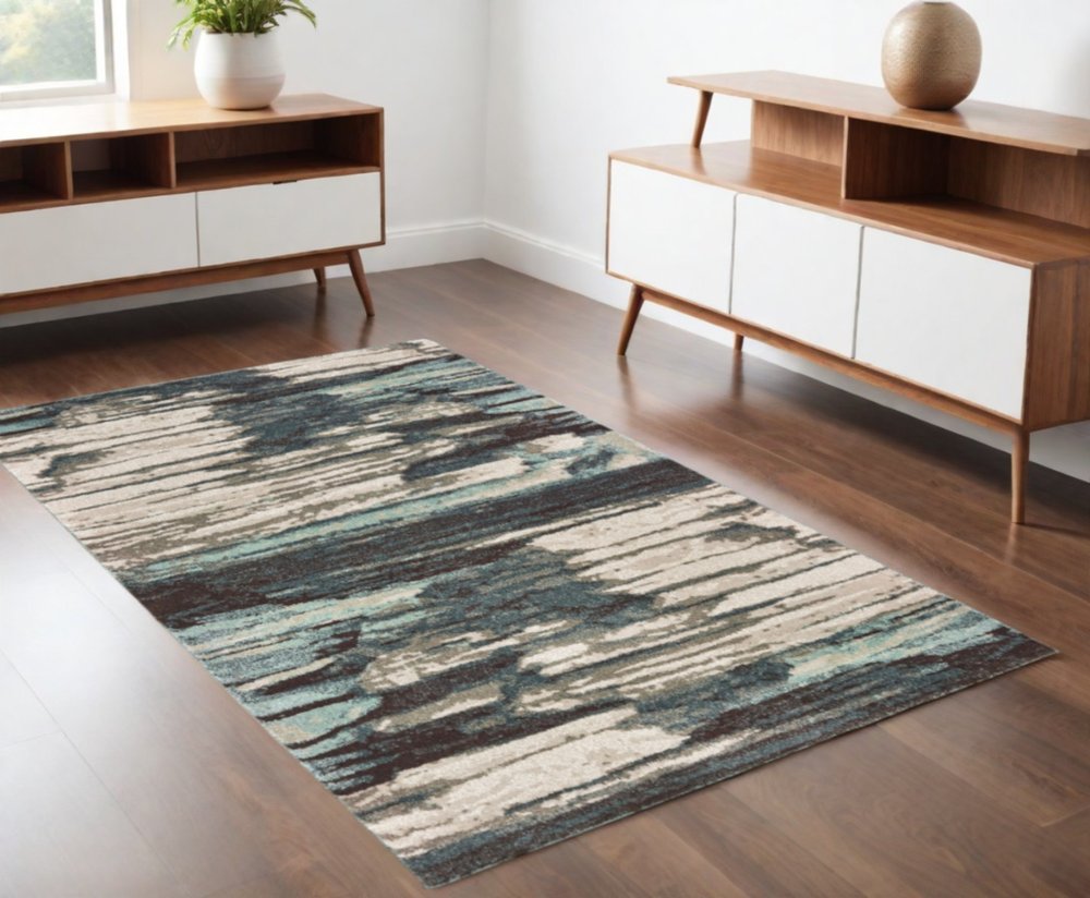 7' X 10' Ivory Blue And Gray Abstract Area Rug