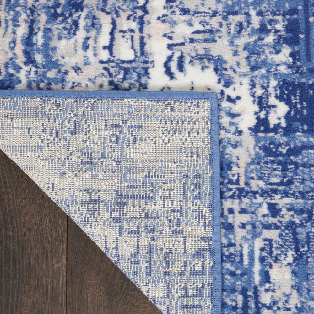 6' X 9' Blue And Ivory Abstract Distressed Area Rug