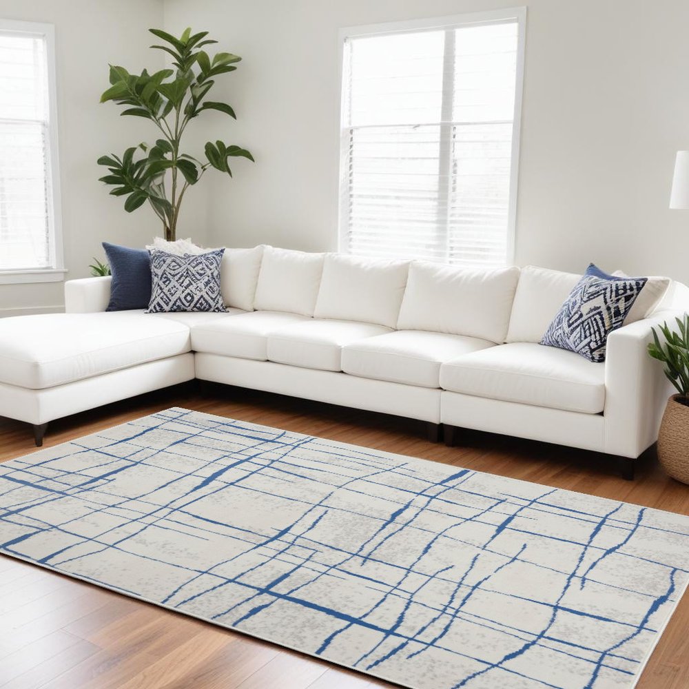 6' X 9' Ivory And Blue Geometric Distressed Area Rug