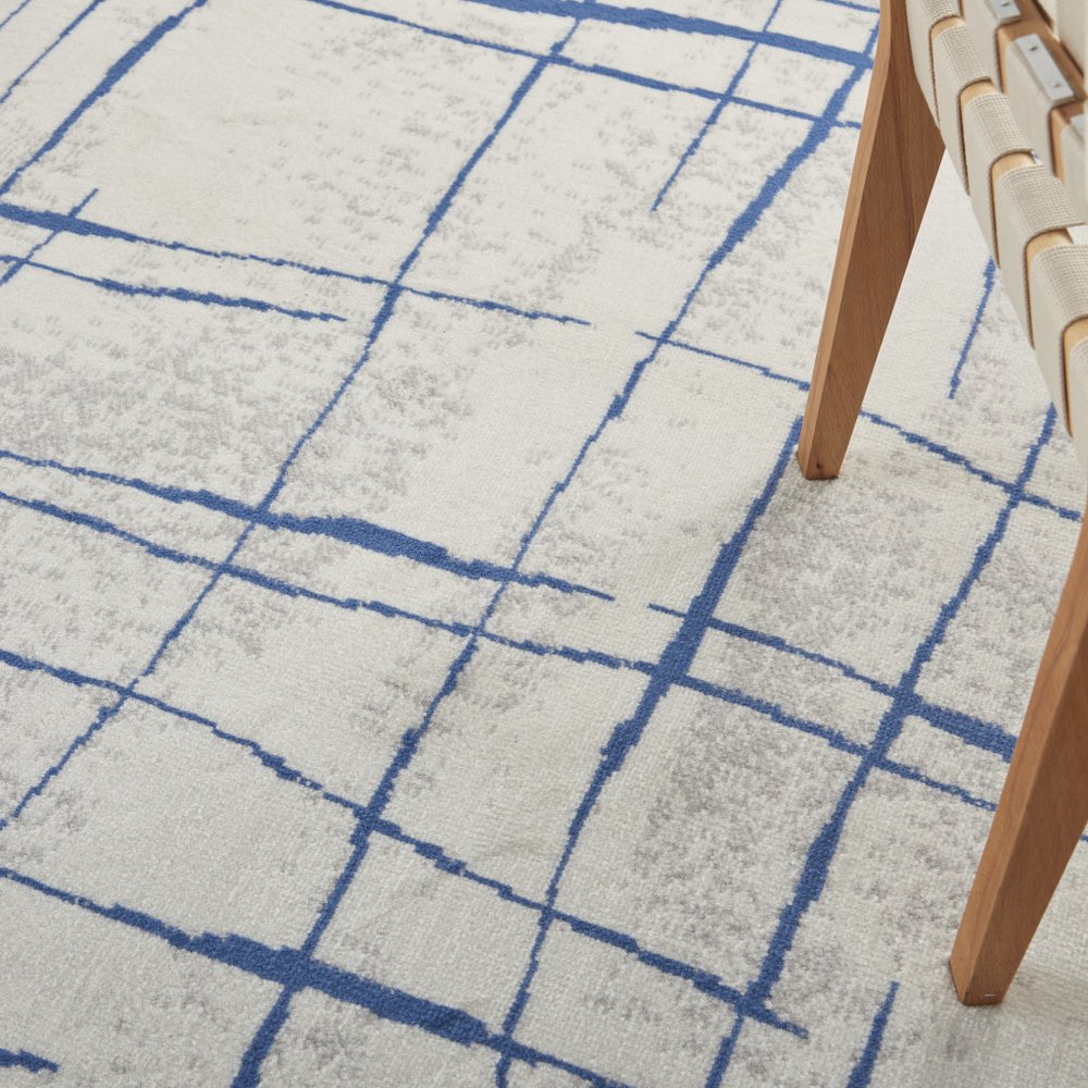 6' X 9' Ivory And Blue Geometric Distressed Area Rug