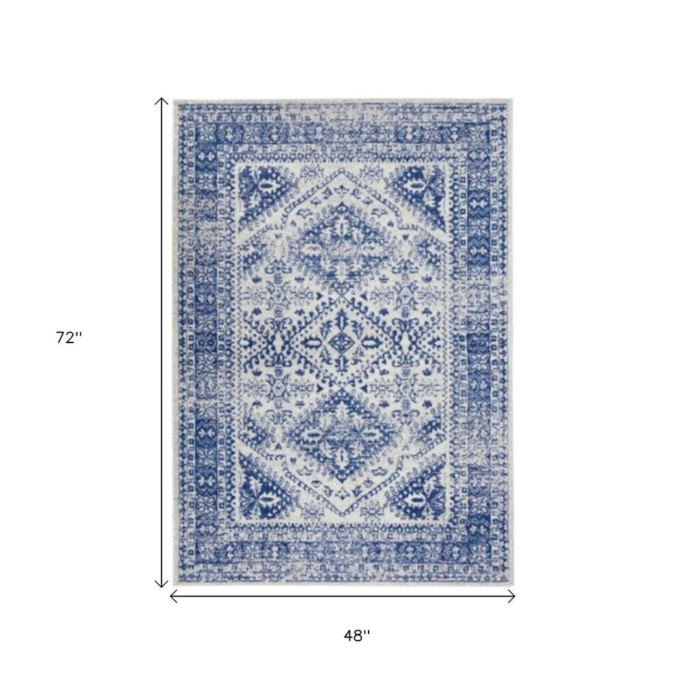 6' X 9' Ivory And Blue Geometric Distressed Area Rug