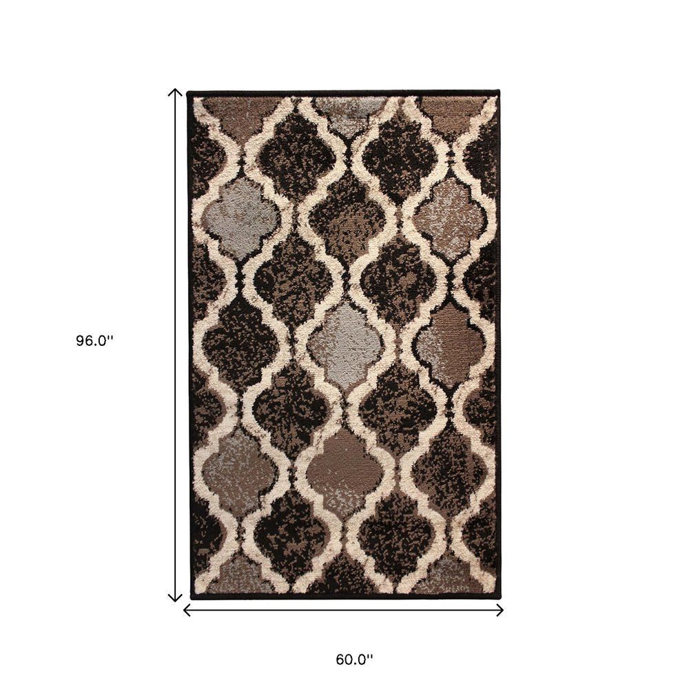 5' X 8' Brown Black And Ivory Quatrefoil Distressed Area Rug