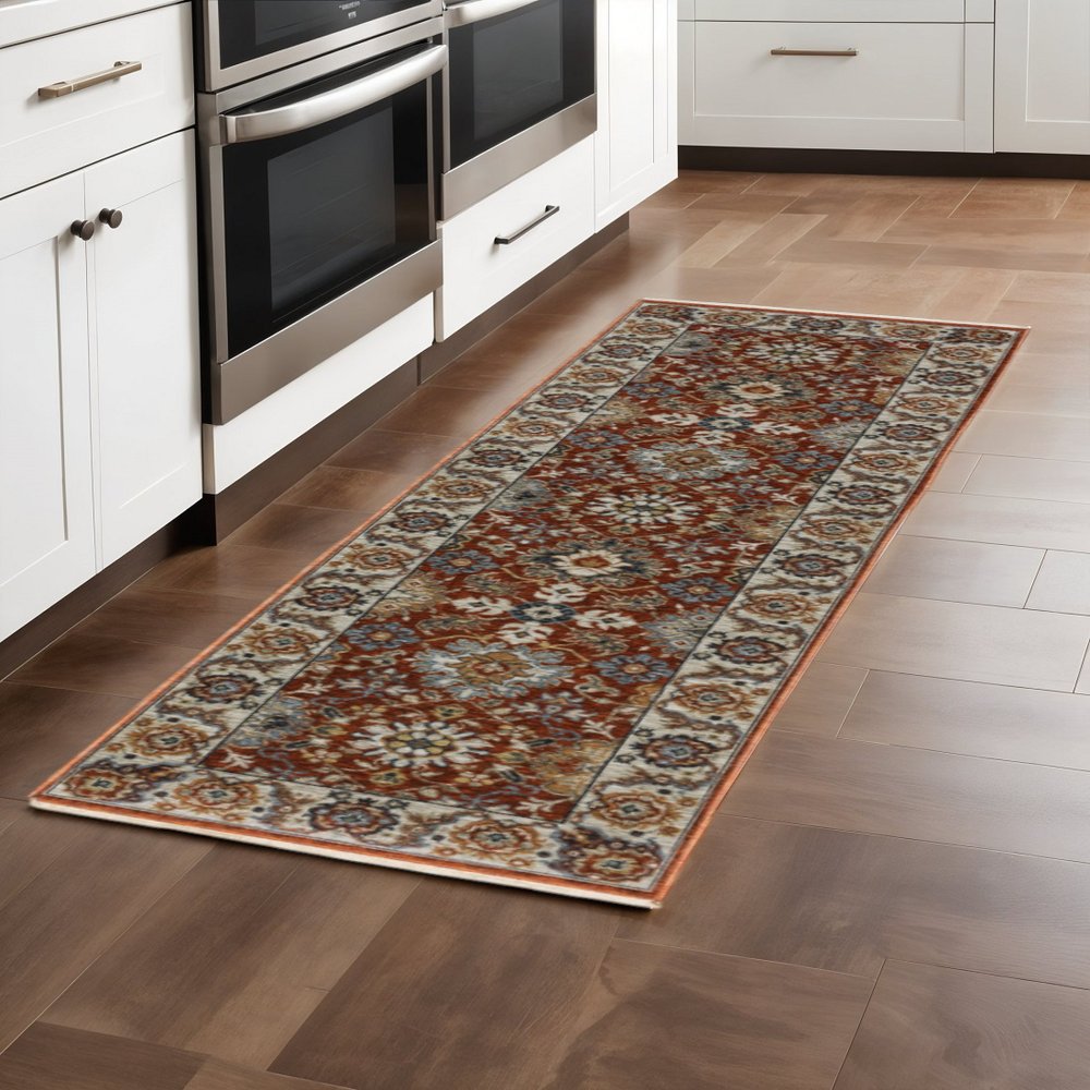 2' X 3' Red Blue Ivory Gold And Navy Oriental Power Loom Stain Resistant Area Rug With Fringe