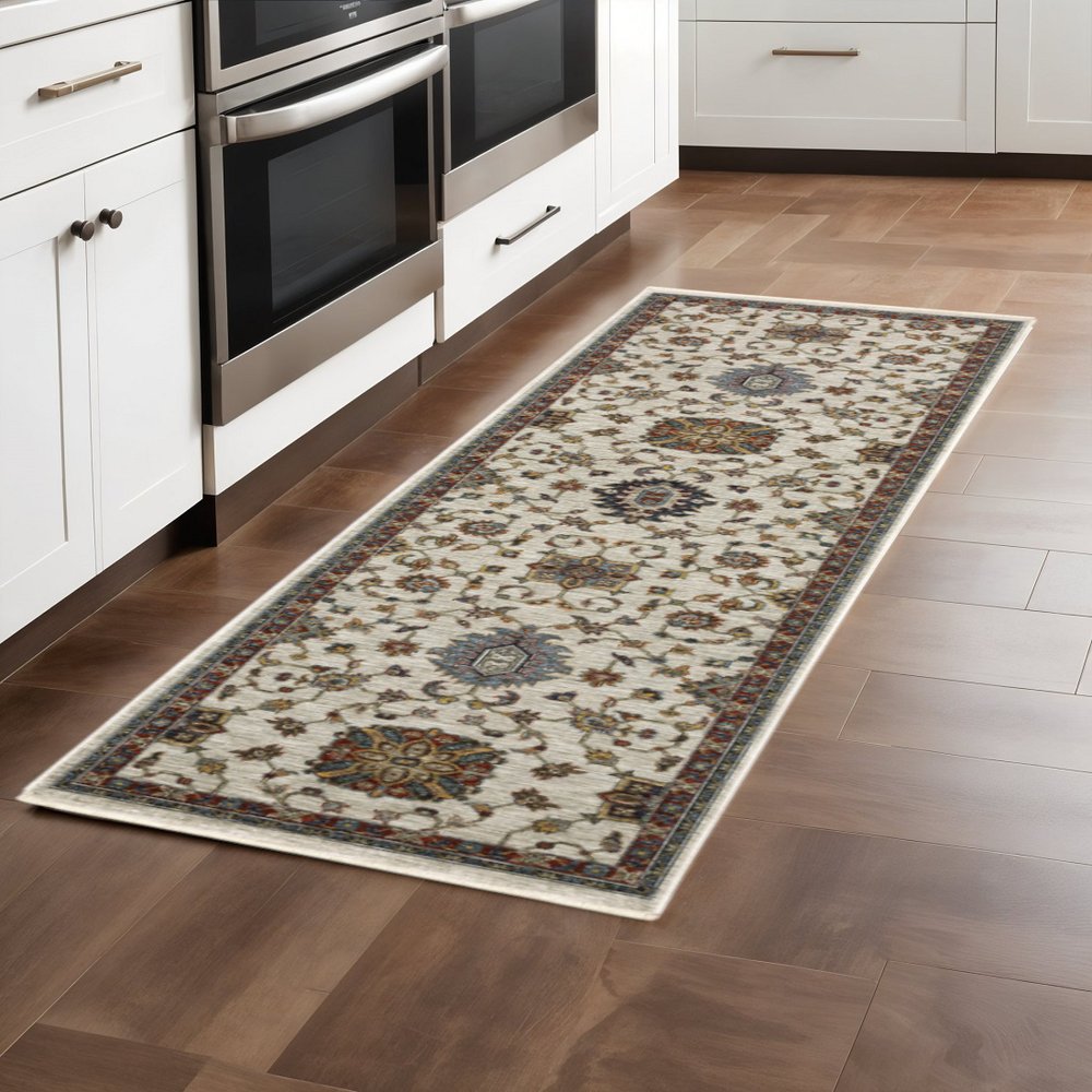 5' X 8' Beige Rust Red Blue Gold And Grey Oriental Power Loom Stain Resistant Area Rug With Fringe