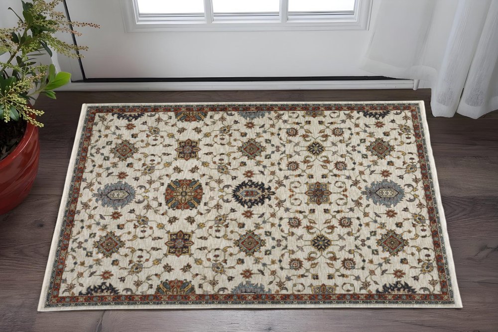5' X 8' Beige Rust Red Blue Gold And Grey Oriental Power Loom Stain Resistant Area Rug With Fringe