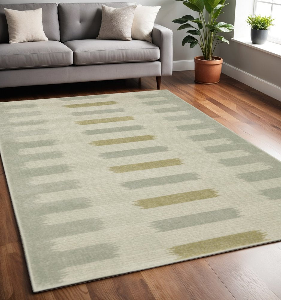 5' X 7' Beige Grey Gold And Green Geometric Power Loom Stain Resistant Area Rug