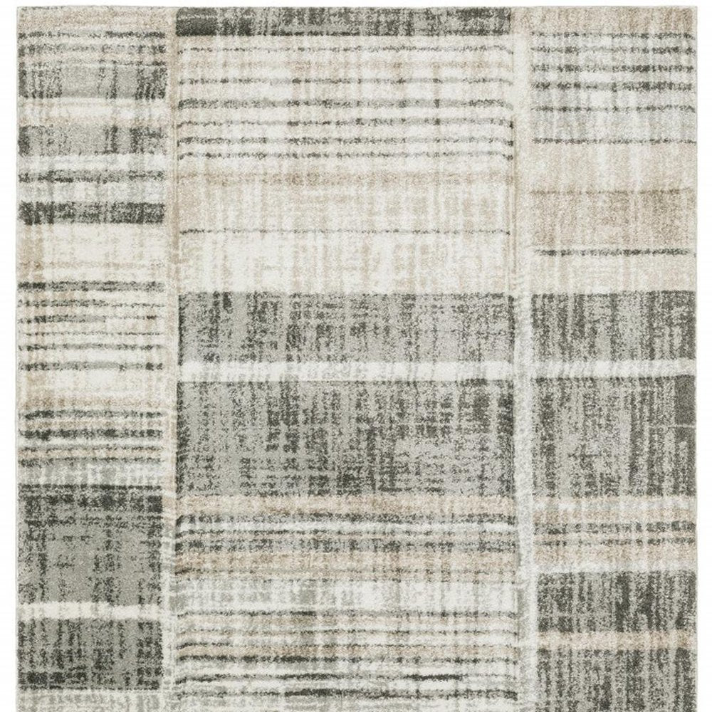 6' X 9' Grey Charcoal Ivory Tan Brown And Beige Geometric Power Loom Stain Resistant Area Rug