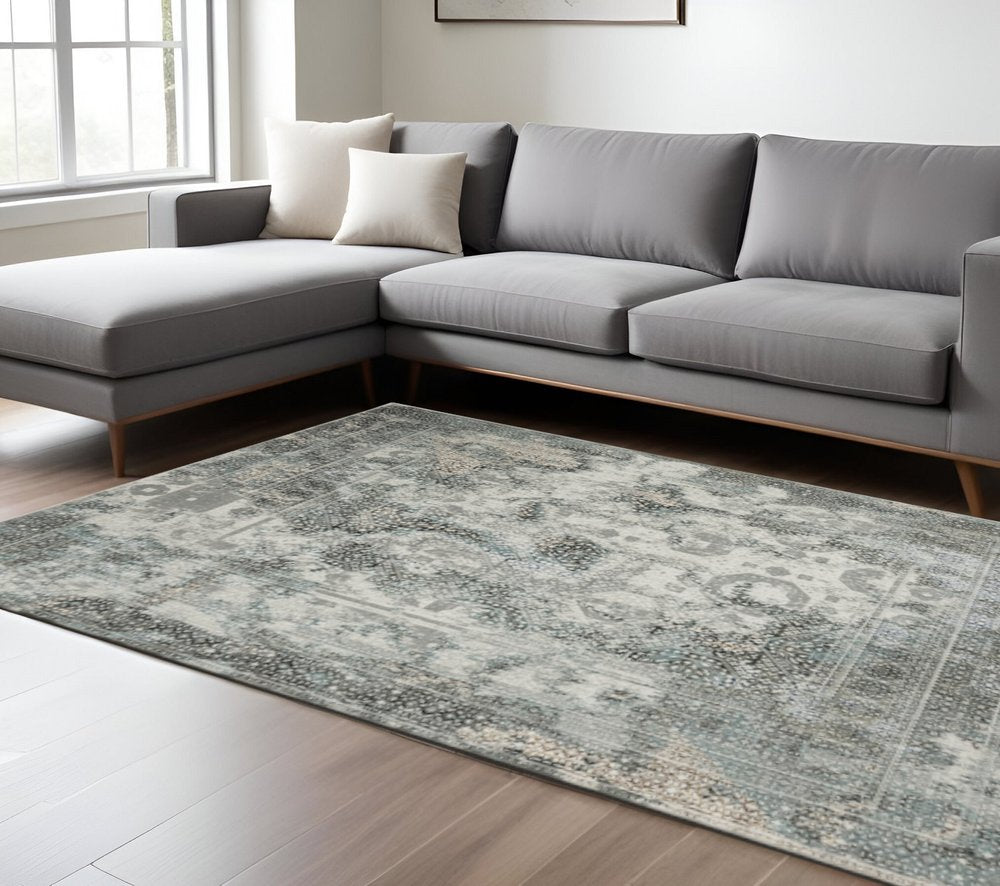 6' X 9' Ivory Grey Charcoal Blue And Rust Oriental Power Loom Stain Resistant Area Rug