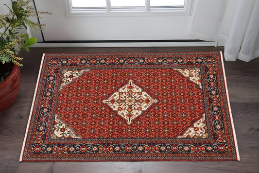 2' X 3' Red Blue Ivory And Orange Oriental Power Loom Stain Resistant Area Rug With Fringe