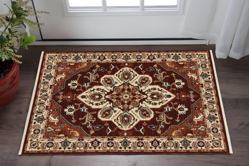 5' X 8' Red Ivory Orange And Blue Oriental Power Loom Stain Resistant Area Rug With Fringe