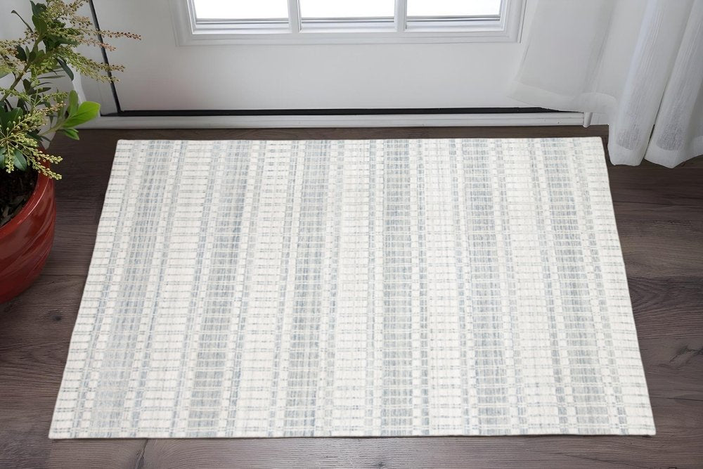 7' X 9' Ivory And Blue Striped Hand Woven Area Rug