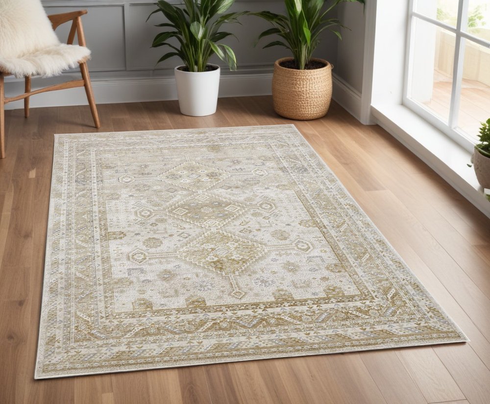 5' X 8' Gold And Ivory Floral Stain Resistant Area Rug