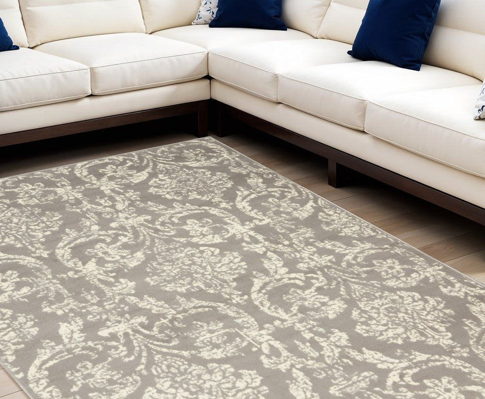6' X 9' Gray and Ivory Damask Power Loom Distressed Area Rug