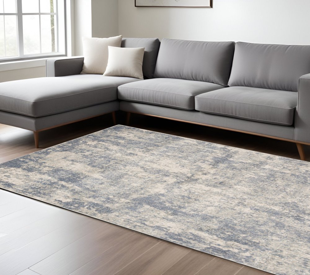 6' X 9' Light Gray Blue And Ivory Abstract Area Rug