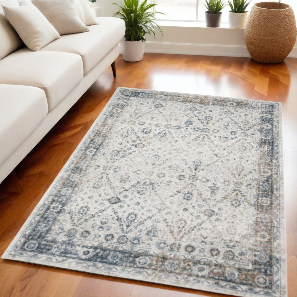 5' X 7' Blue and Ivory Floral Medallion Power Loom Distressed Washable Area Rug
