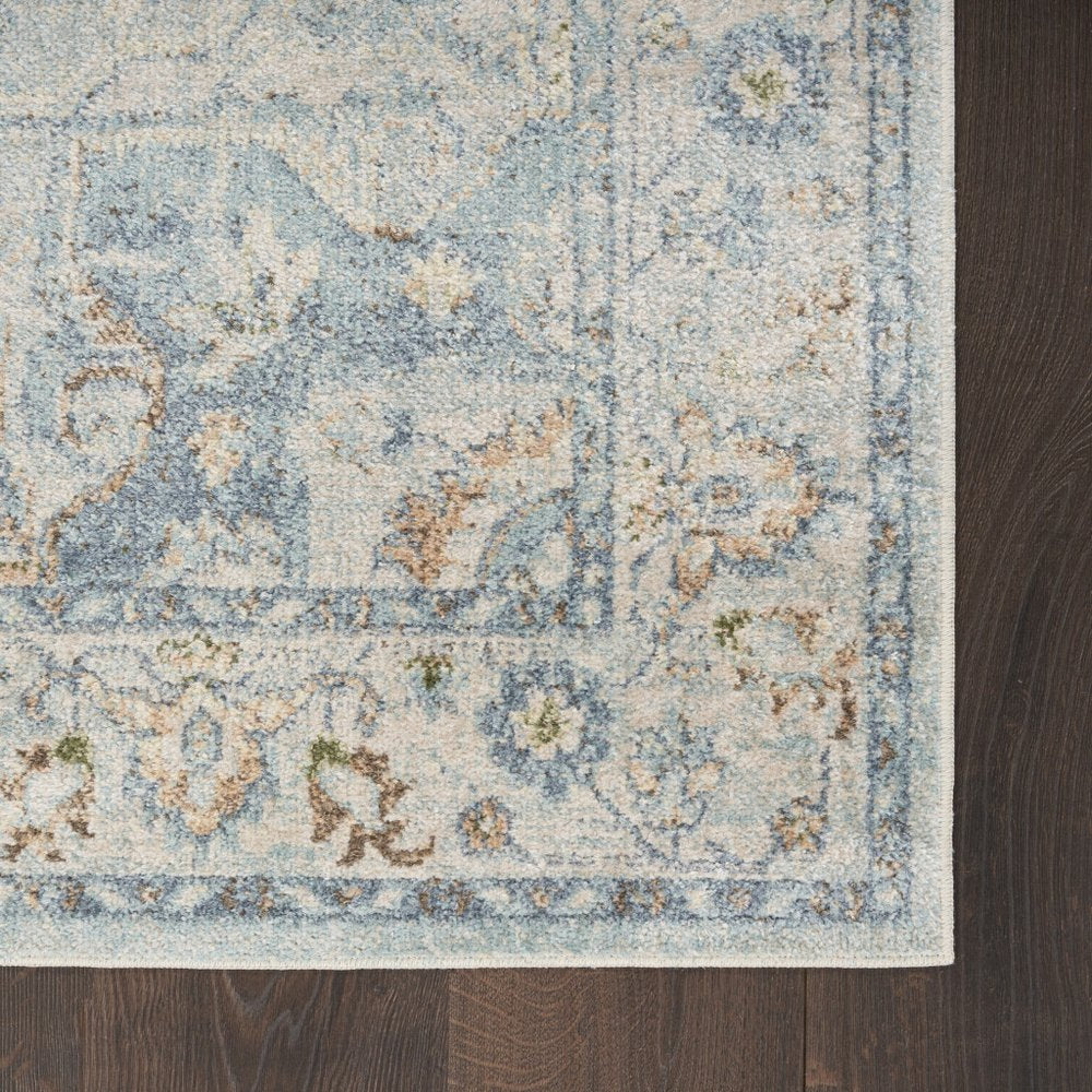 7' X 9' Blue and Ivory Floral Medallion Power Loom Distressed Washable Area Rug
