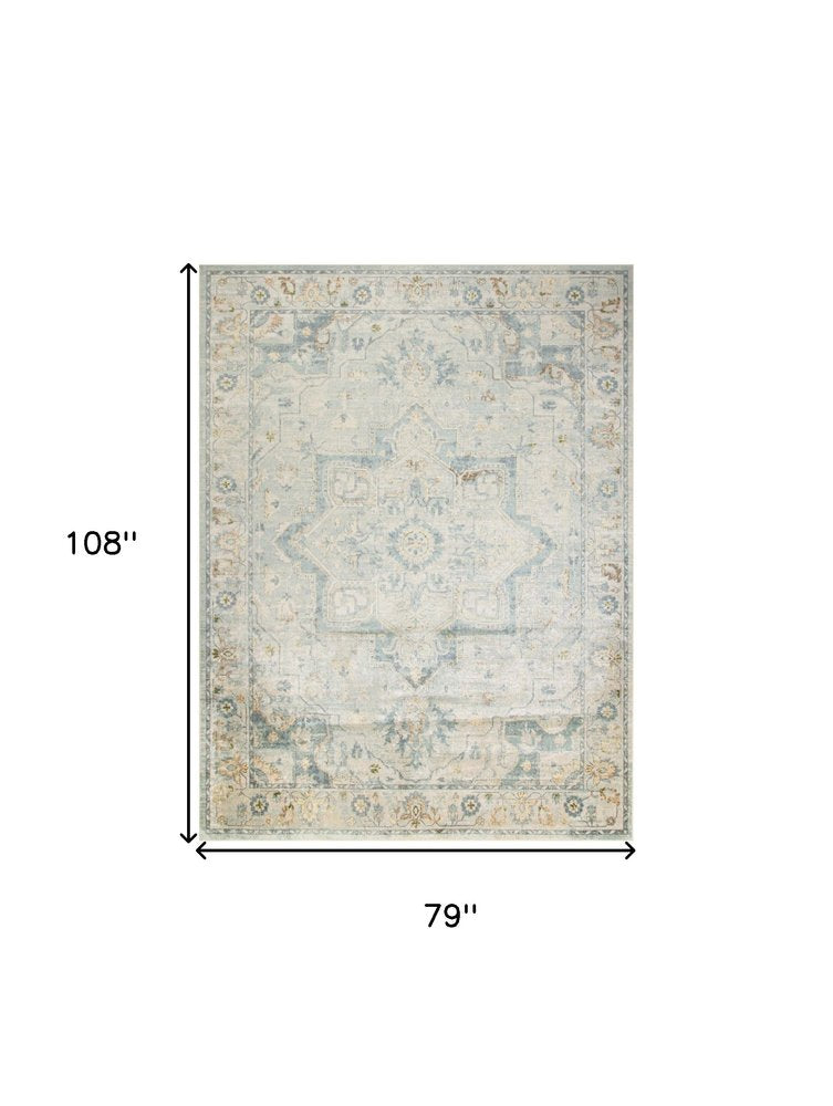 7' X 9' Blue and Ivory Floral Medallion Power Loom Distressed Washable Area Rug