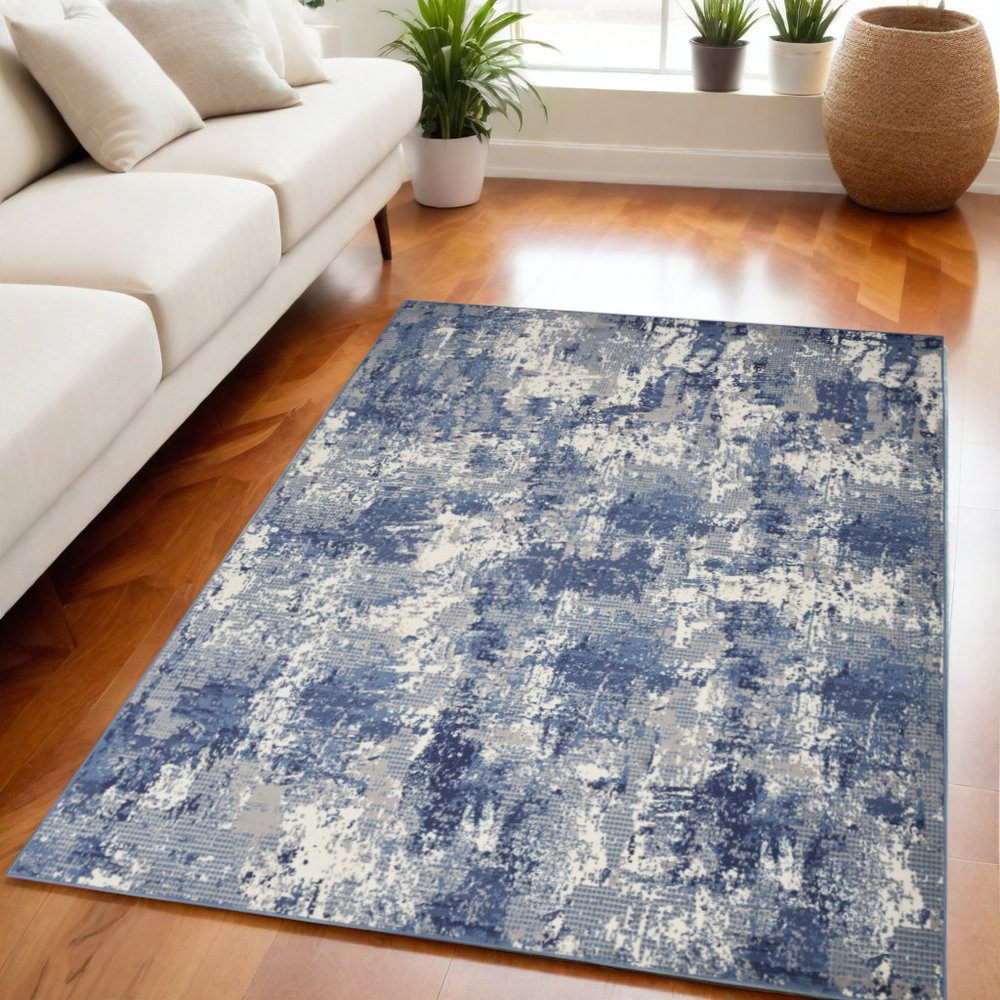 5' X 7' Blue and Ivory Abstract Power Loom Area Rug