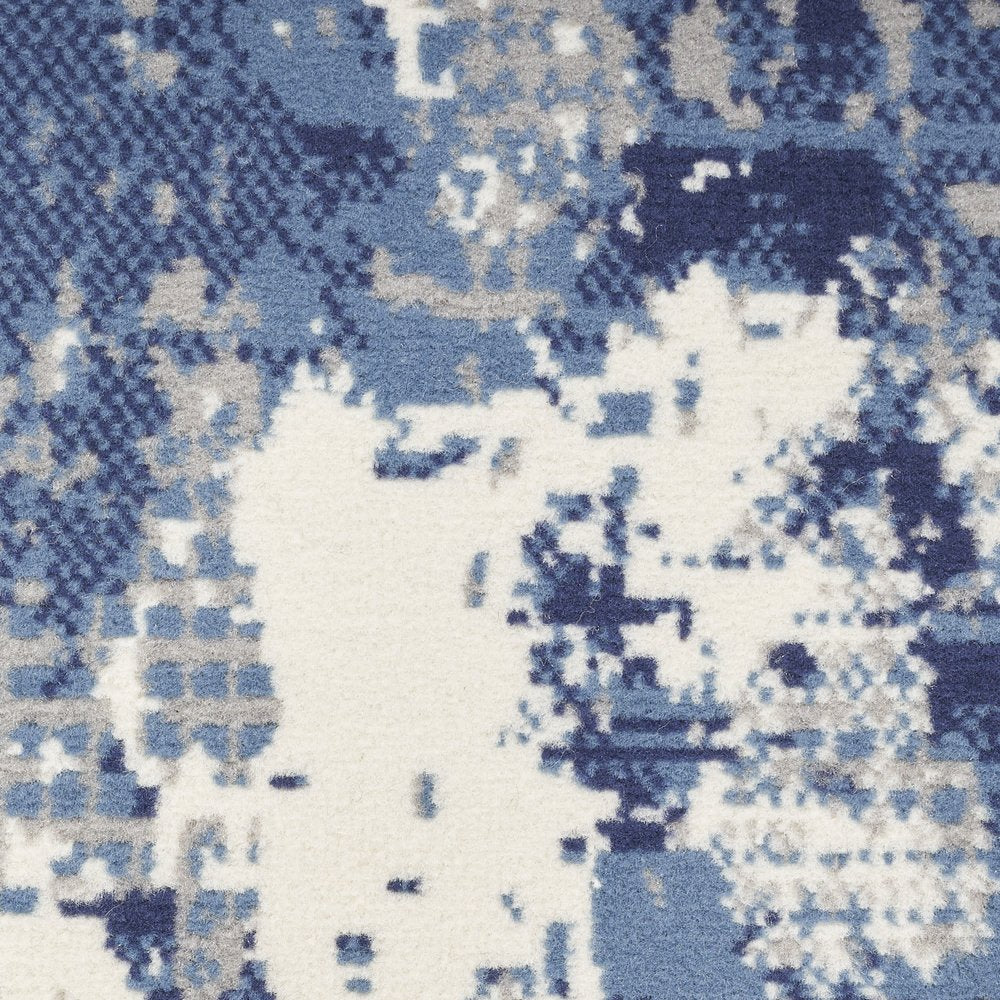 5' X 7' Blue and Ivory Abstract Power Loom Area Rug