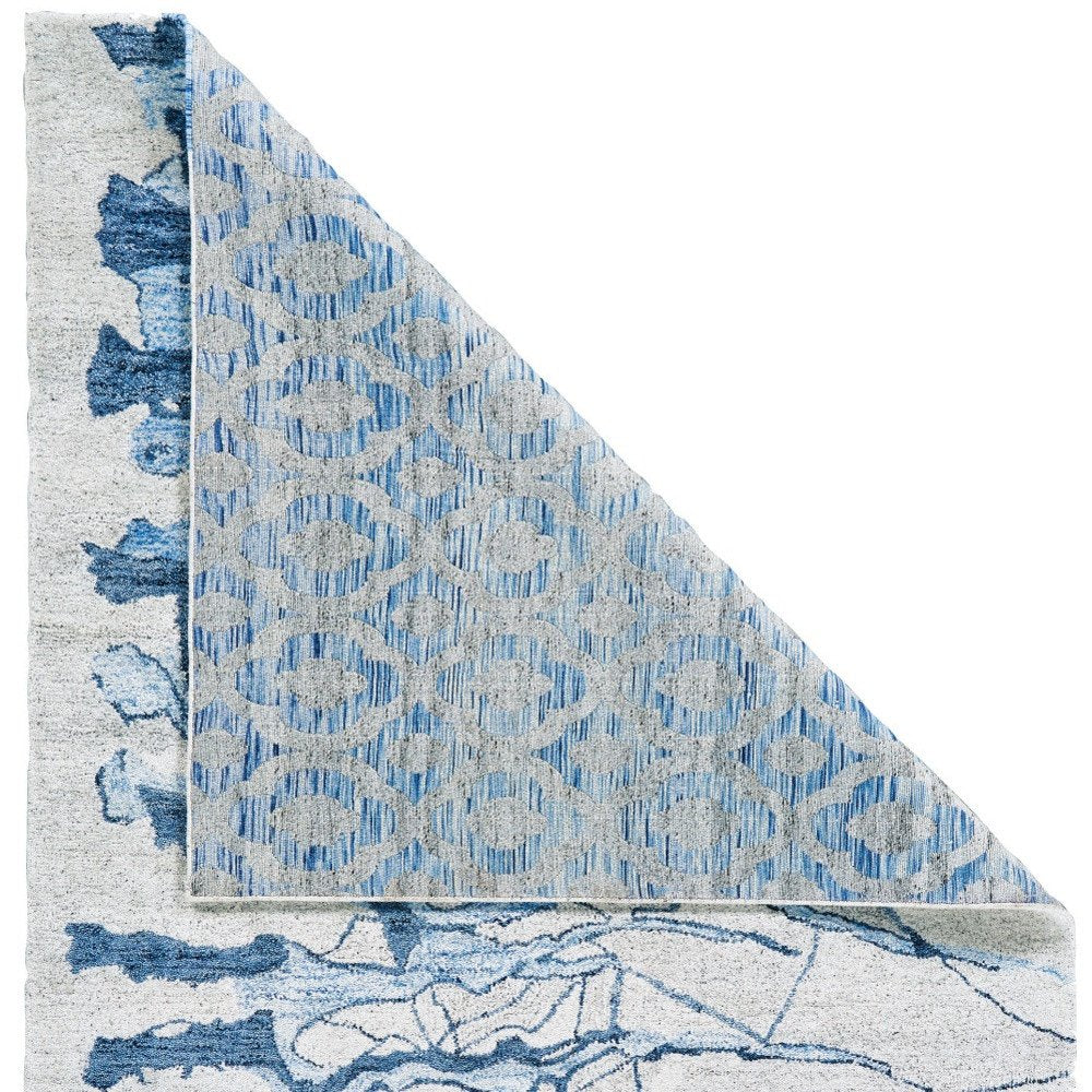7' X 9' Blue and Ivory Abstract Hand Tufted Area Rug