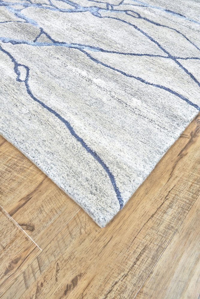 7' X 9' Blue and Ivory Abstract Hand Tufted Area Rug