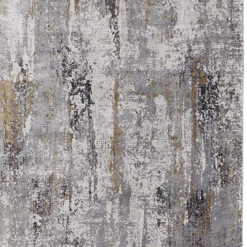 3' X 5' Gray Ivory and Gold Abstract Power Loom Area Rug With Fringe