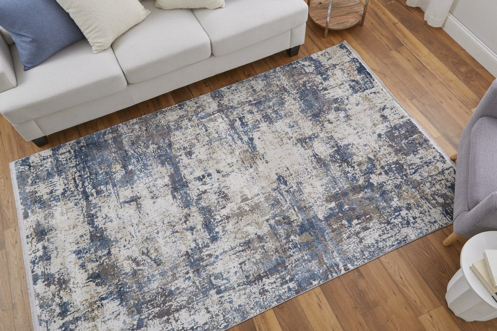 3' X 5' Ivory Tan and Blue Abstract Power Loom Area Rug With Fringe