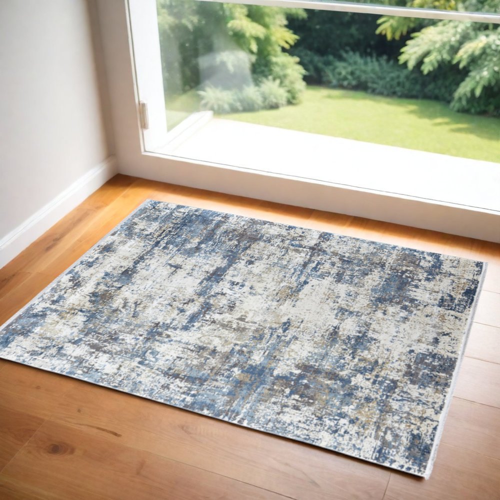 3' X 5' Ivory Tan and Blue Abstract Power Loom Area Rug With Fringe