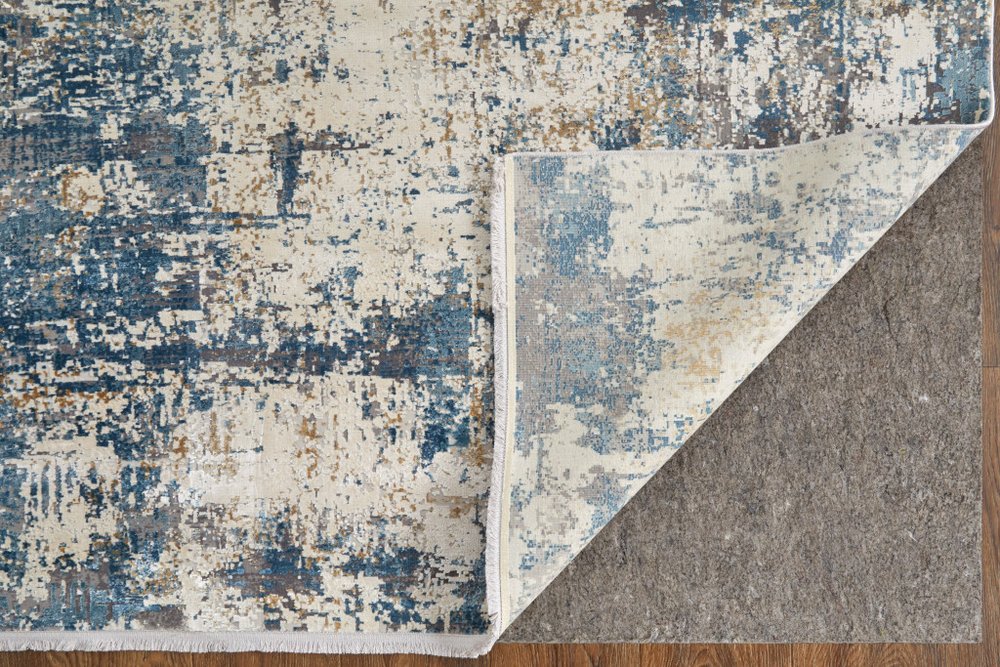 3' X 5' Ivory Tan and Blue Abstract Power Loom Area Rug With Fringe