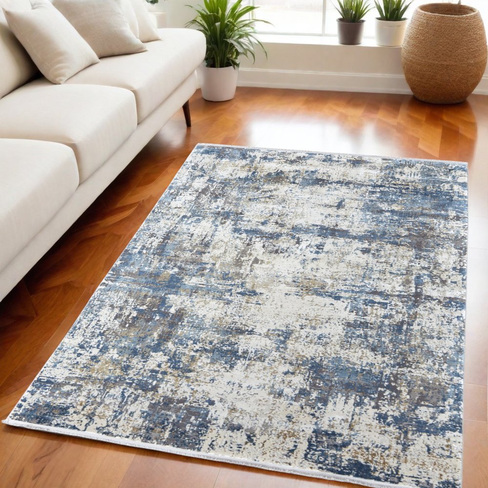 3' X 5' Ivory Tan and Blue Abstract Power Loom Area Rug With Fringe