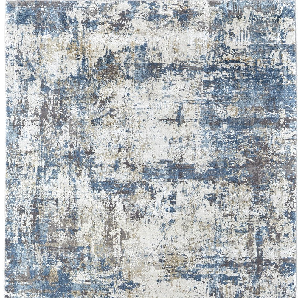 3' X 5' Ivory Tan and Blue Abstract Power Loom Area Rug With Fringe