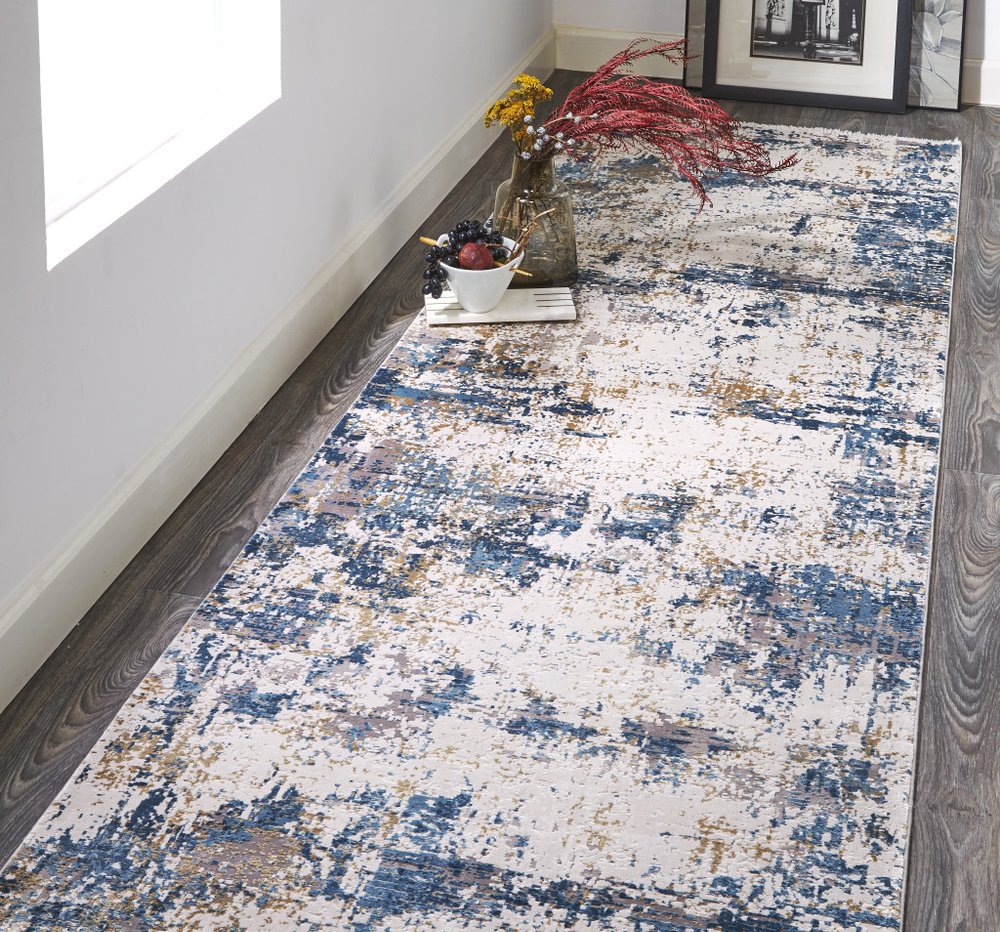 3' X 5' Ivory Tan and Blue Abstract Power Loom Area Rug With Fringe