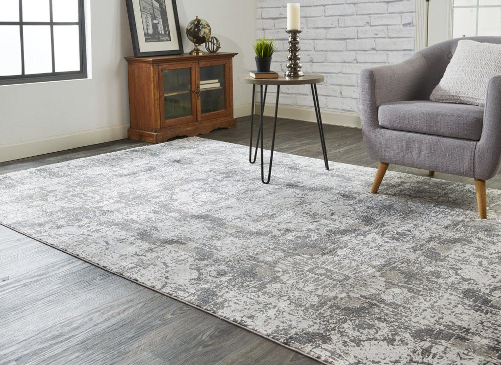 5' X 8' Ivory Taupe and Gray Abstract Power Loom Distressed Area Rug With Fringe