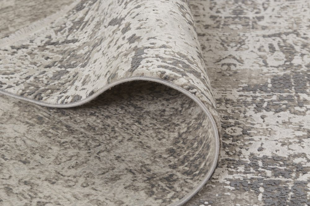 5' X 8' Ivory Taupe and Gray Abstract Power Loom Distressed Area Rug With Fringe