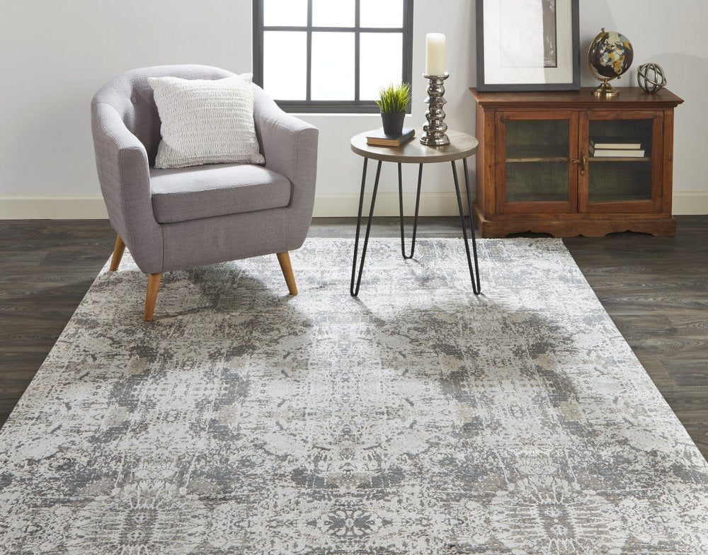 5' X 8' Ivory Taupe and Gray Abstract Power Loom Distressed Area Rug With Fringe