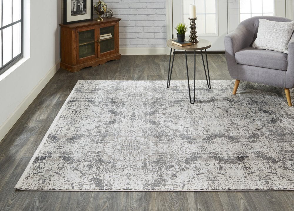 5' X 8' Ivory Taupe and Gray Abstract Power Loom Distressed Area Rug With Fringe
