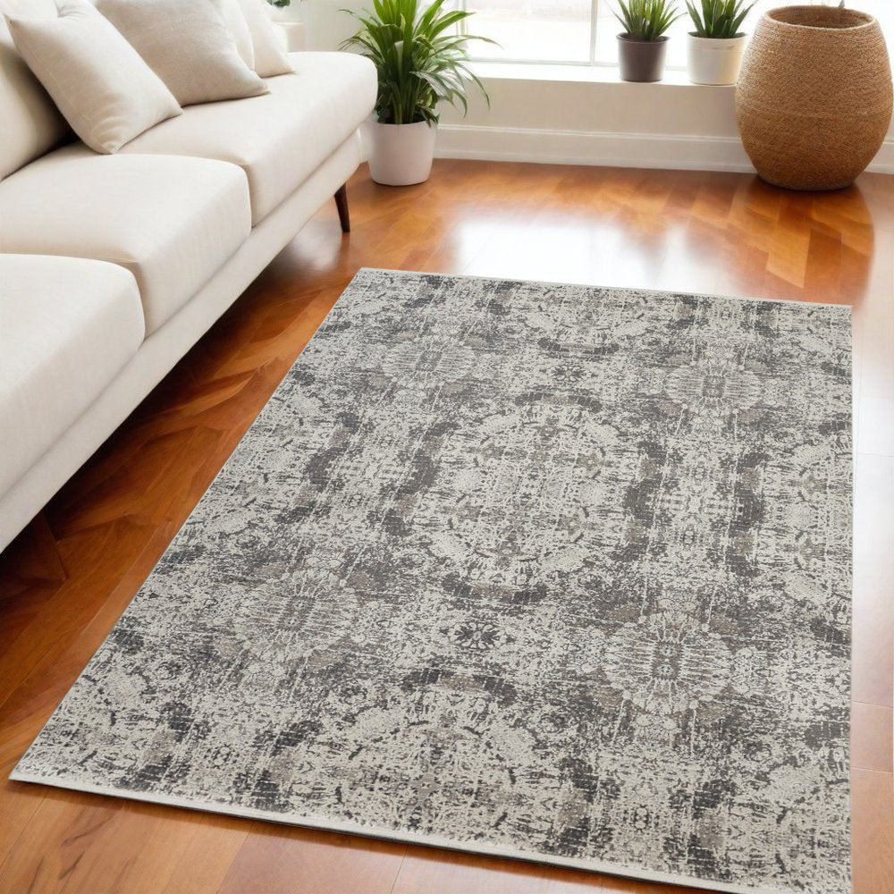 5' X 8' Ivory Taupe and Gray Oriental Power Loom Area Rug With Fringe