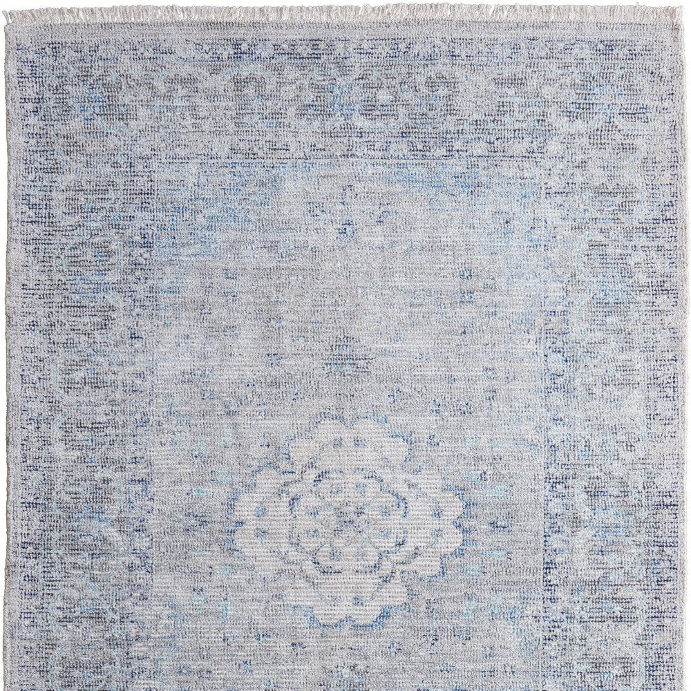 5' X 8' Gray Blue and Ivory Oriental Hand Woven Distressed Area Rug With Fringe