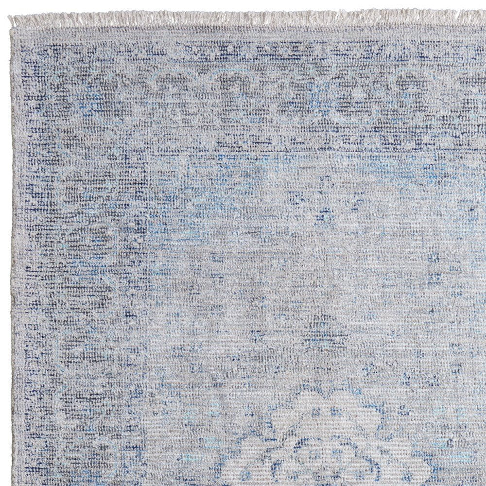 5' X 8' Gray Blue and Ivory Oriental Hand Woven Distressed Area Rug With Fringe