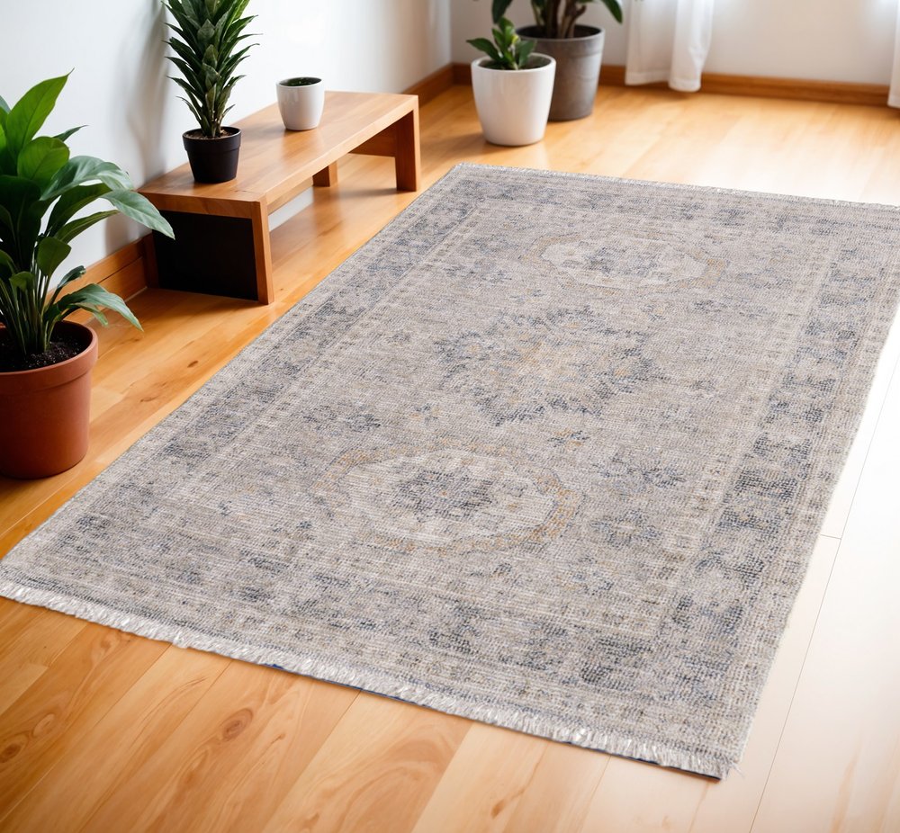4' X 6' Tan and Gray Oriental Hand Woven Distressed Area Rug With Fringe