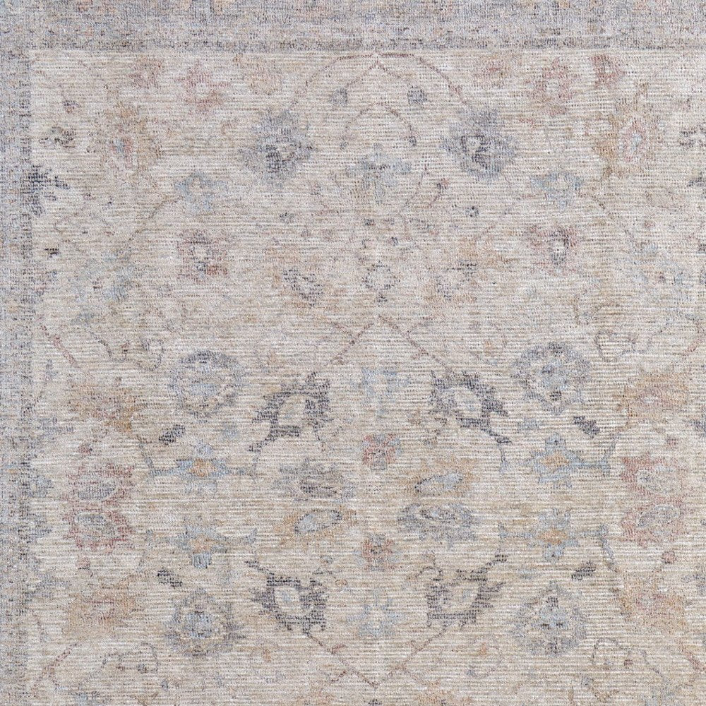 4' X 6' Ivory Tan and Blue Floral Hand Woven Distressed Area Rug With Fringe
