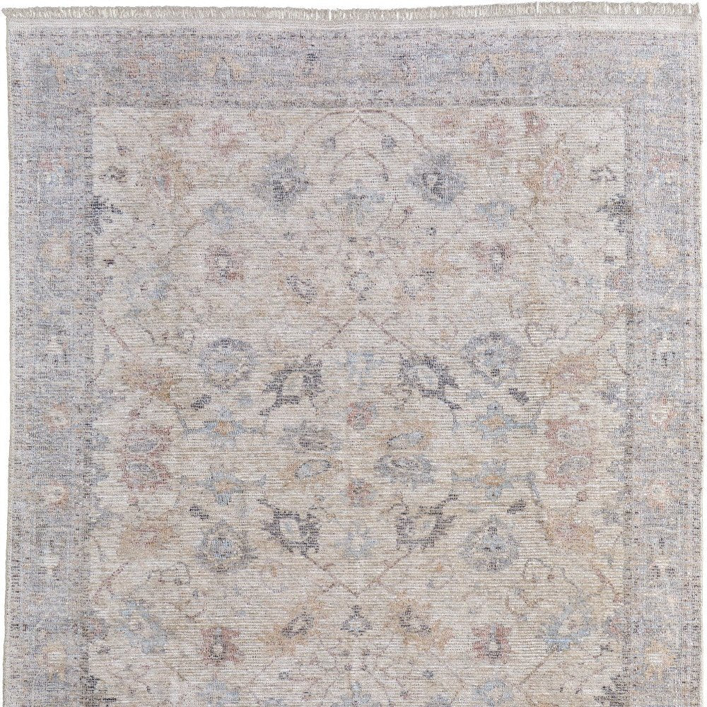 4' X 6' Ivory Tan and Blue Floral Hand Woven Distressed Area Rug With Fringe