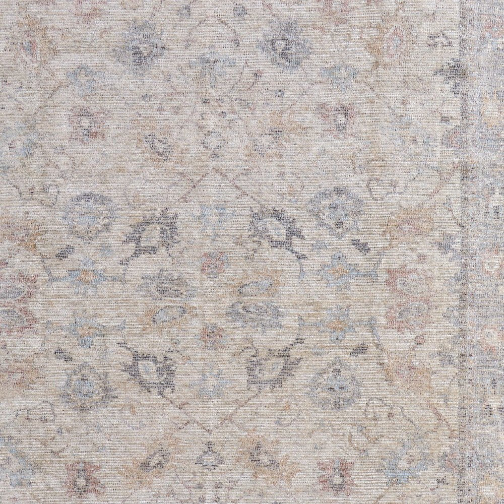 4' X 6' Ivory Tan and Blue Floral Hand Woven Distressed Area Rug With Fringe