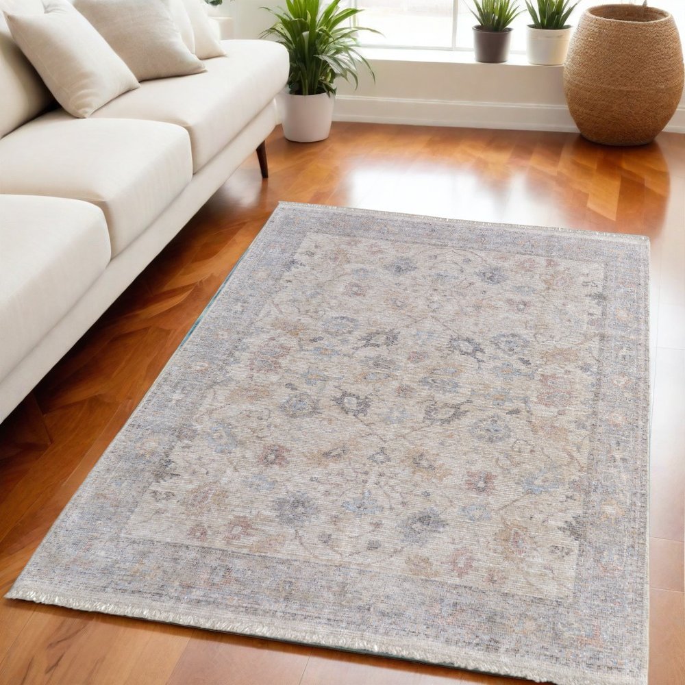 4' X 6' Ivory Tan and Blue Floral Hand Woven Distressed Area Rug With Fringe