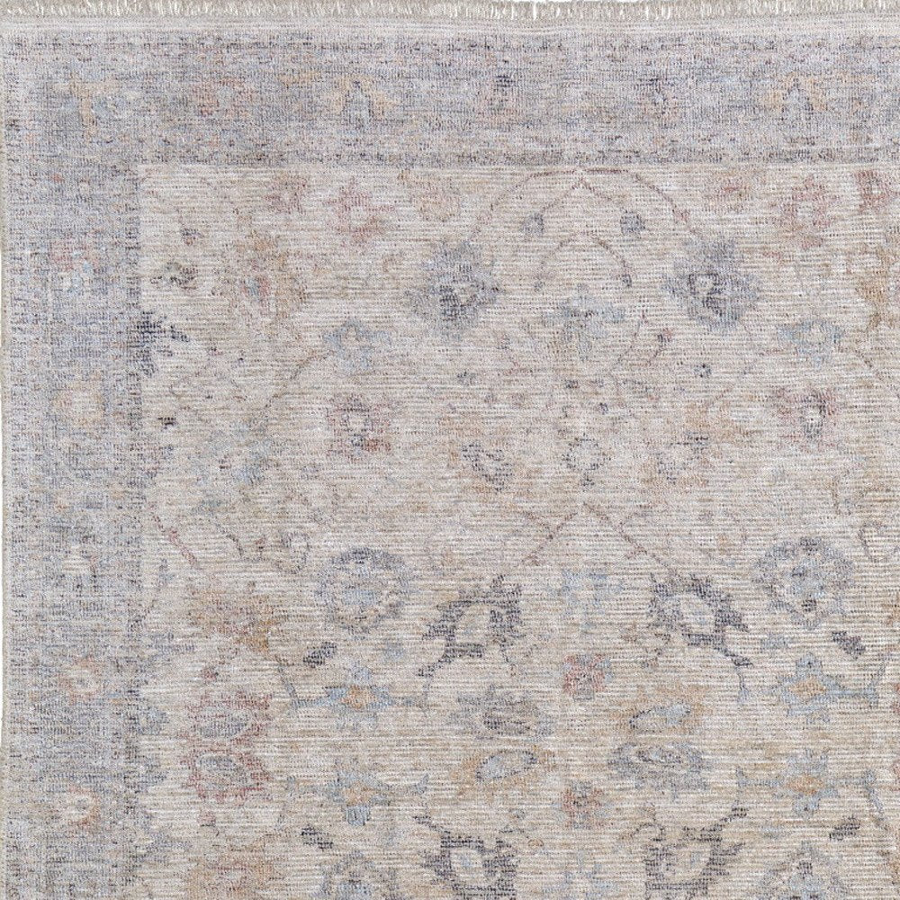 4' X 6' Ivory Tan and Blue Floral Hand Woven Distressed Area Rug With Fringe