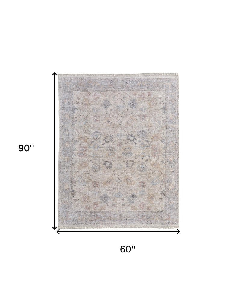 4' X 6' Ivory Tan and Blue Floral Hand Woven Distressed Area Rug With Fringe