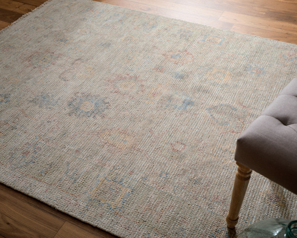 4' X 6' Tan Brown and Blue Floral Hand Woven Distressed Area Rug With Fringe