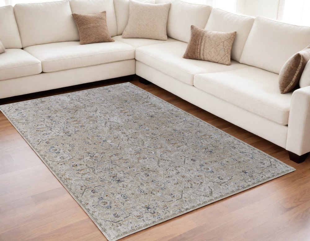 5' X 8' Ivory Taupe and Blue Abstract Power Loom Worn Faded Area Rug With Fringe